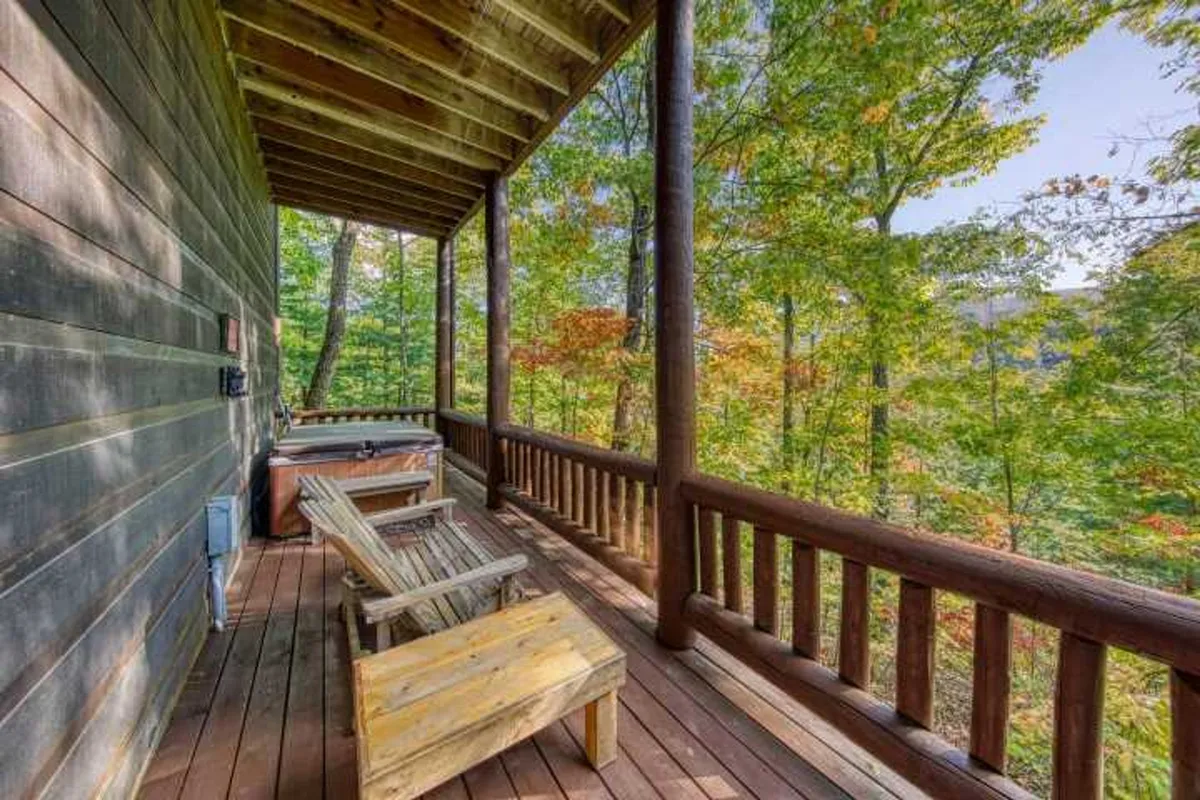 A serene wooden deck features a bubbling hot tub overlooking lush trees, with a tranquil atmosphere perfect for unwinding. The hot tub is placed to maximize the view, inviting guests to soak while soaking in nature’s beauty. A cozy conversation area is nearby for sharing stories or simply enjoying the stillness.